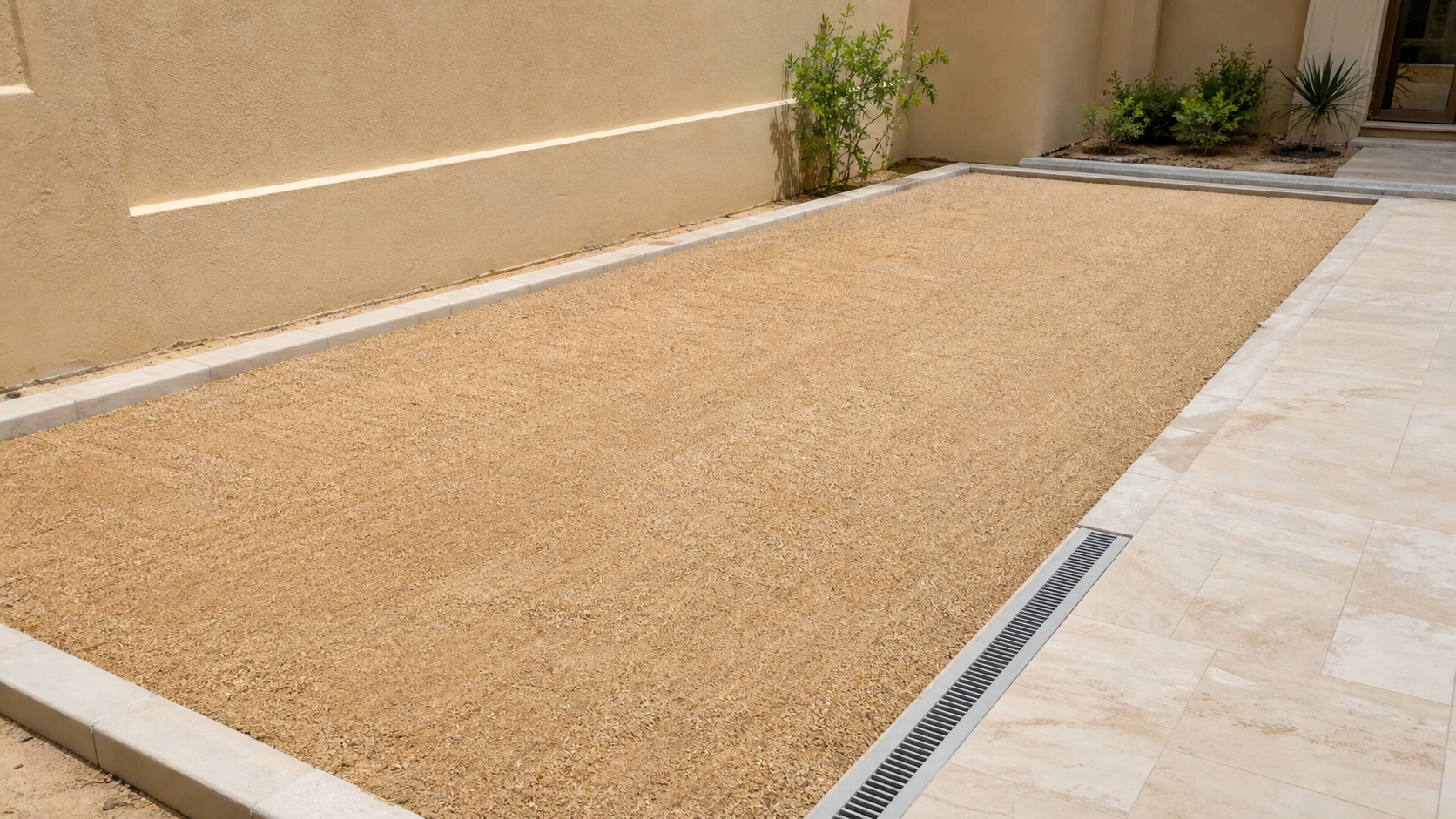 level compacted aggregate base prepared for artificial grass in a Dubai villa garden