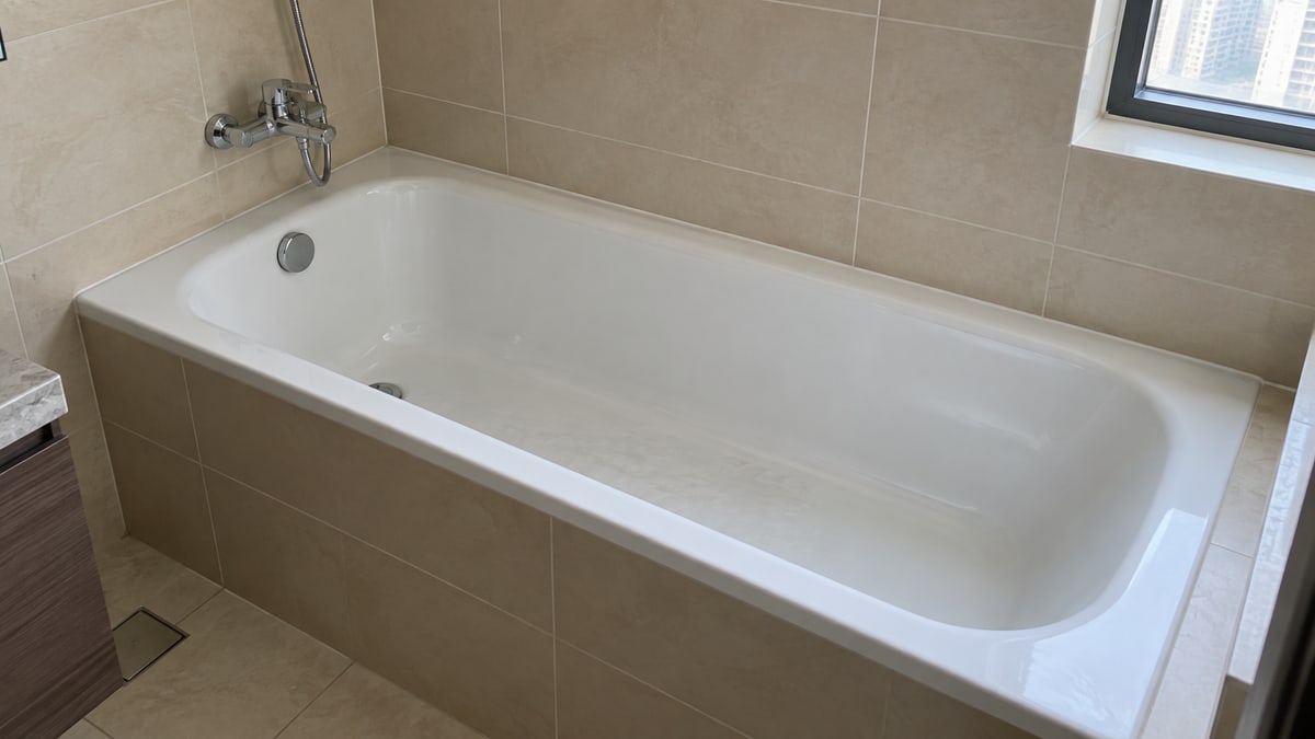 Bathtub and adjacent tiled walls in a bathroom