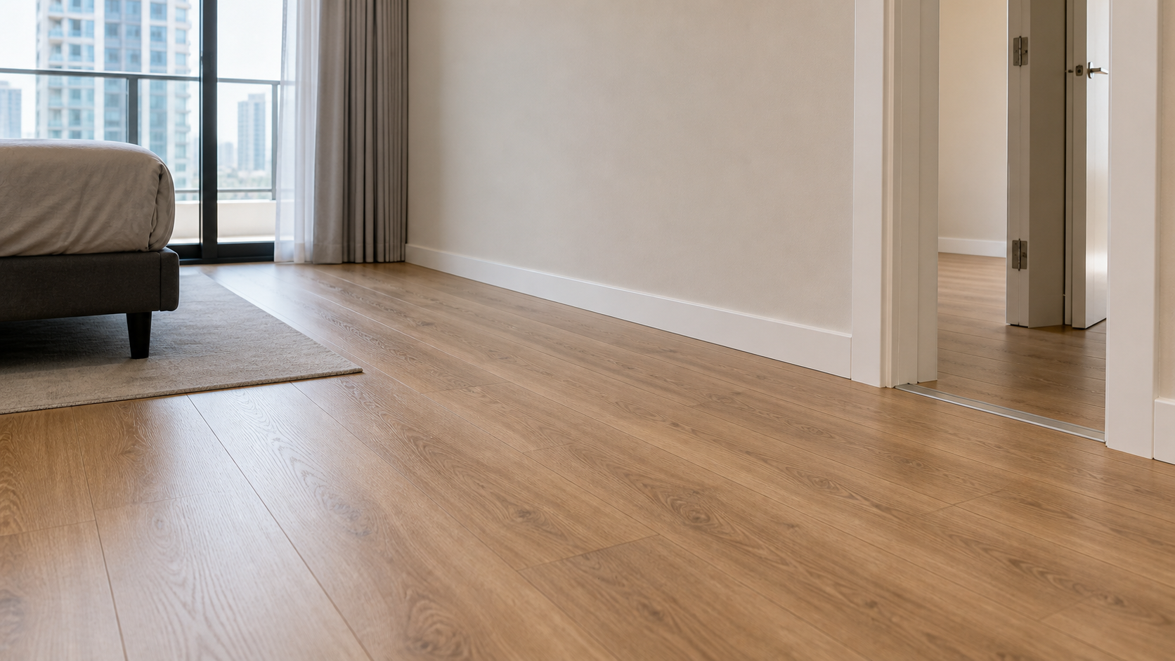 finished laminate flooring with skirting and door trim in a Dubai apartment