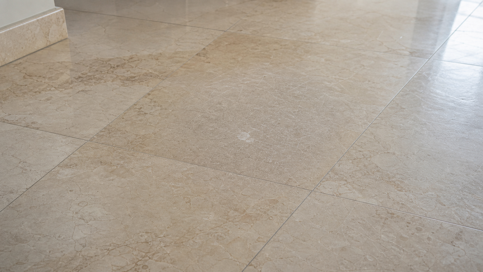 close view of genuine marble floor tiles with dull traffic wear and light surface scratches